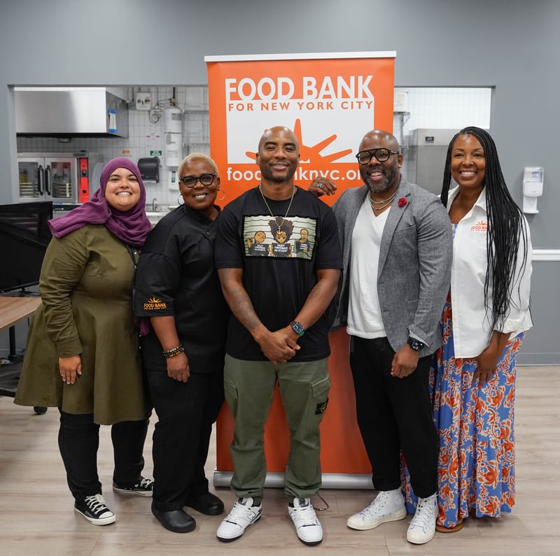 Charlamagne tha God poses with Food Bank staff at Food Bank For New York City Community Kitchen.