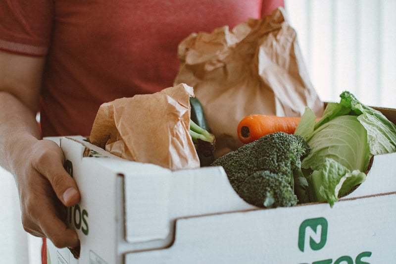 Man carrying a box of produce